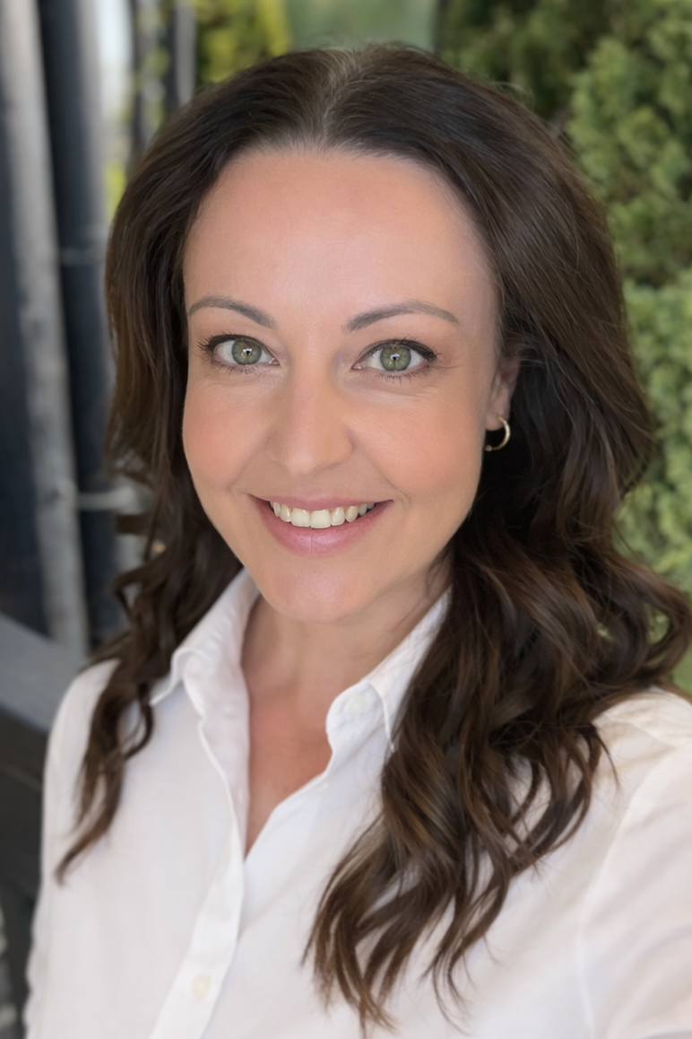 Woman wearing a white shirt with a blurred outdoor background